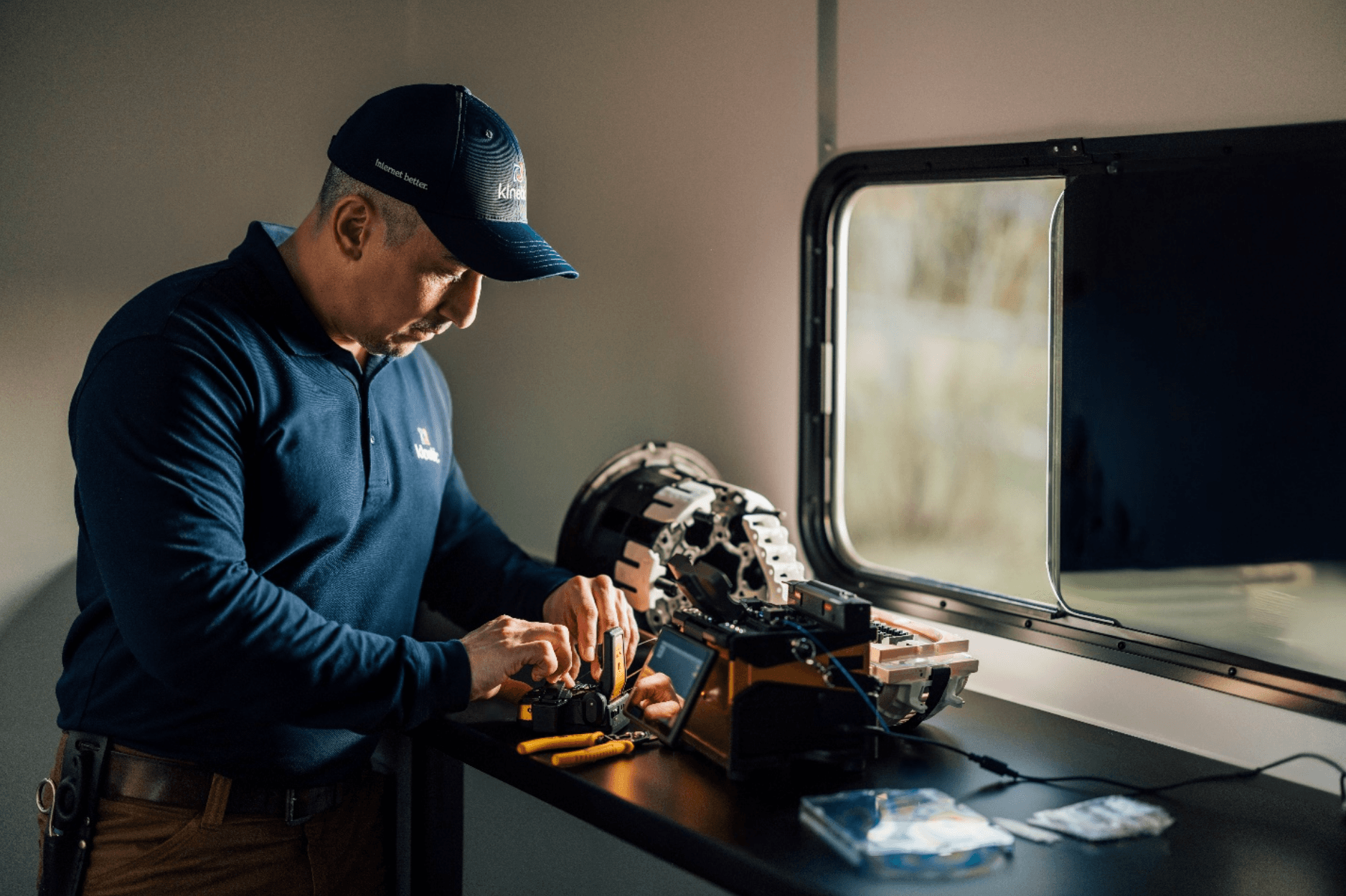 A technician inspects a fiber optic cable for maintenance